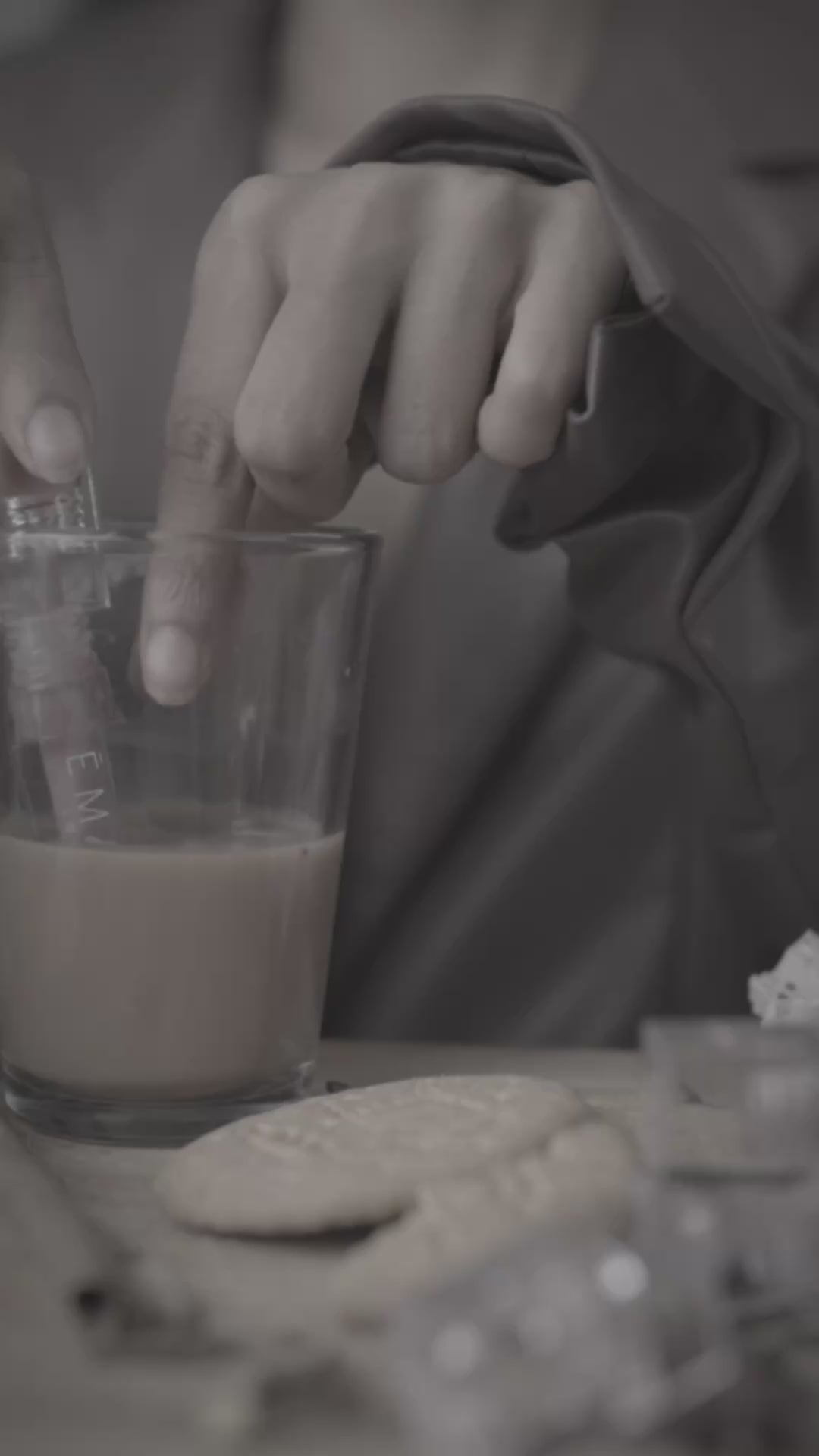 Load video: Video of girl taking the Karaak Chai Lip Oil out of a glass of karaak, opening the oil and applying it to her lips